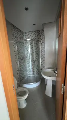 a bathroom with a shower and a toilet and a sink at dekra bouznika in Bouznika