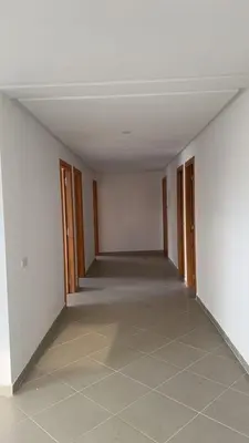 an empty room with white walls and a tile floor at dekra bouznika in Bouznika