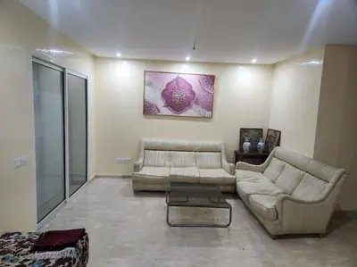 a living room with a couch and a table at Apartment Ocean View in O Ben Slimane