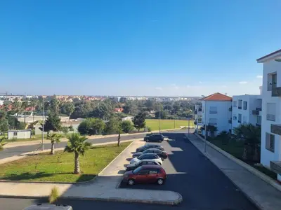 a row of cars parked in a parking lot at Apartment Ocean View in O Ben Slimane
