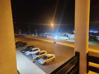 a group of cars parked in a parking lot at night at Apartment Ocean View in O Ben Slimane