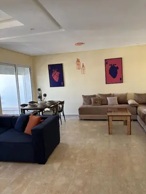 a living room with a couch and a table at Apartment with pool view, 1 min to beach, private parking in Pont Blondin