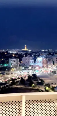 a view of a city at night with traffic at Appartement CFC vue sur mer et sur la ville in Anfa