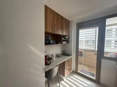 a small kitchen with a desk and a window at Luxery 2mars in Casablanca