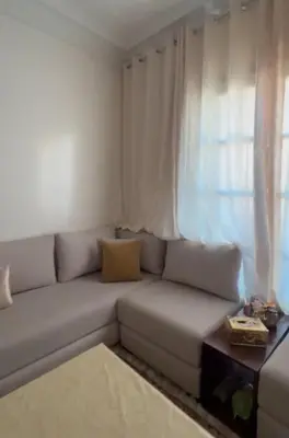 a white couch in a living room with a window at La maison in Casablanca