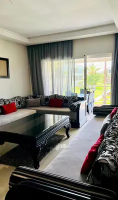 a living room with a couch and a table at Ola Blanca in Sidi Rahal