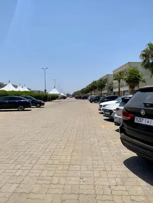 a parking lot with a lot of cars parked at Ola Blanca in Sidi Rahal