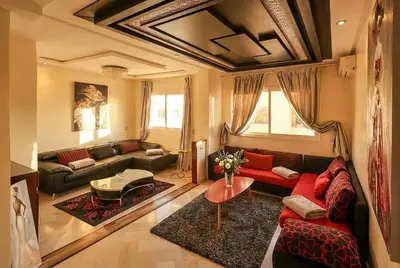 a living room with a couch and a table at Spacious City Bourgogne in Maarif