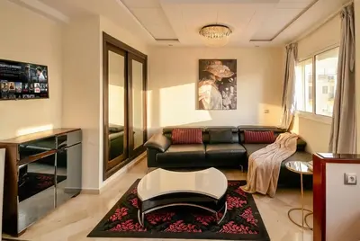 a living room with a couch and a table at Spacious City Bourgogne in Maarif