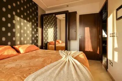 a bedroom with a bed with a dress on it at Spacious City Bourgogne in Maarif