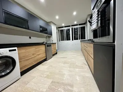 a large kitchen with a washer and dryer in it at 3 Rooms & View in Casablanca