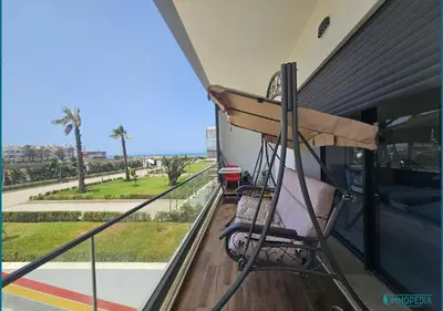 a room with a balcony with a swing at Escapade océane à El Mansouria in Mansouria