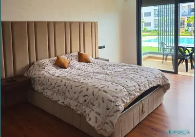a bedroom with a bed with a view of a patio at Escapade océane à El Mansouria in Mansouria