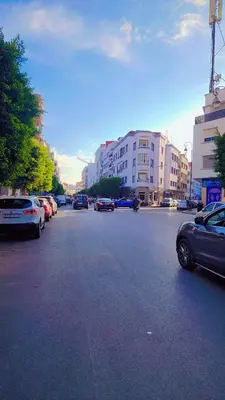 a city street with cars parked on the street at Hachem in Rabat