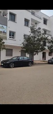 a black car parked in front of a building at Hachem in Rabat