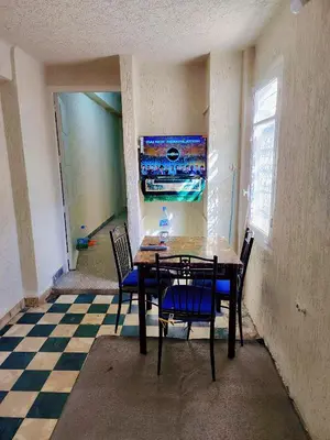 a dining room with a table and chairs on a checkered floor at Hachem in Rabat