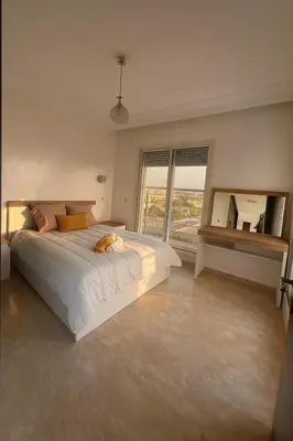 a bedroom with a large bed and a large window at Casablanca in panoramic mode in Casablanca