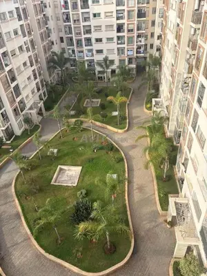 a park in the middle of a city with tall buildings at Casablanca in panoramic mode in Casablanca