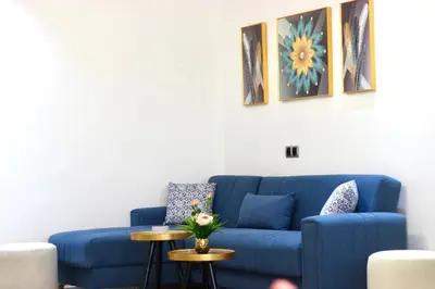 a blue couch in a living room with two tables at Stunning Views & Prime Location! in Casablanca