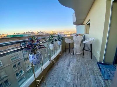 a balcony with chairs and a view of a city at Stunning Views & Prime Location! in Casablanca