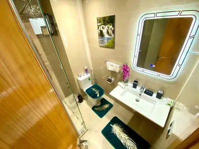 a bathroom with a sink and a toilet and a mirror at Stunning Views & Prime Location! in Casablanca