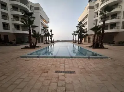 a swimming pool in the middle of a building at Charmant appartement à Anfa in Casablanca
