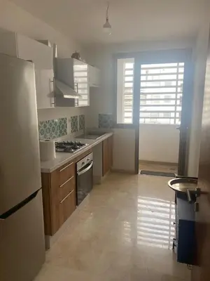 a kitchen with a refrigerator and a stove at Charmant appartement à Anfa in Casablanca