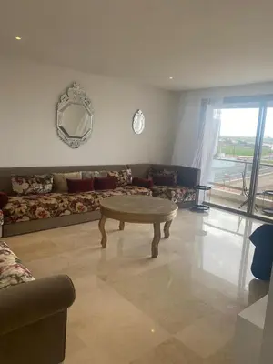a living room with a couch and a coffee table at Charmant appartement à Anfa in Casablanca