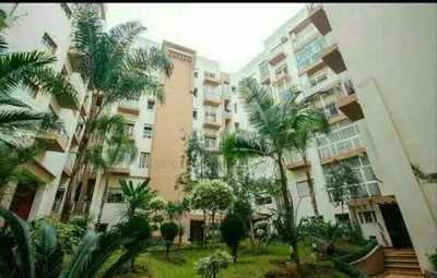 a large building with palm trees in front of it at Home Stay Casa in Casablanca