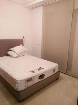a bed in a room with a white mattress at Home Stay Casa in Casablanca