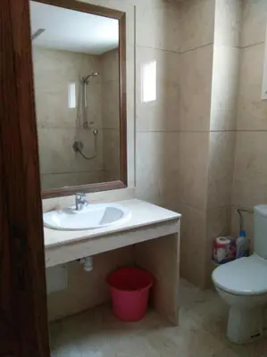 a bathroom with a sink and a toilet and a mirror at Home Stay Casa in Casablanca