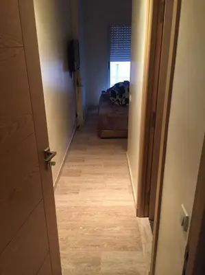 a hallway with a door leading to a room with a bed at Home Stay Casa in Casablanca