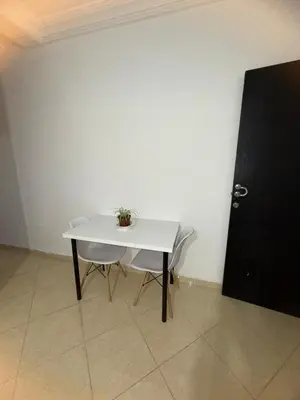 a white table with a plant on it next to a door at Appartement situated 10 min from city center in Settat