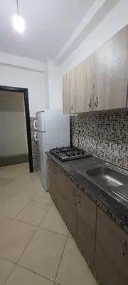 a kitchen with a stove and a sink and a refrigerator at Appartement situated 10 min from city center in Settat