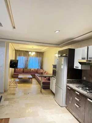 a kitchen and a living room with a couch at Flora Nora - Central Tramway - by Mi-haven in Casablanca