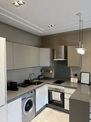a kitchen with white cabinets and a washer and dryer at Flora Nora - Central Tramway - by Mi-haven in Casablanca