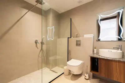 a bathroom with a shower and a toilet and a sink at Design 1BR Living Home M5 Stadium Balcony & Private Parking in Maarif