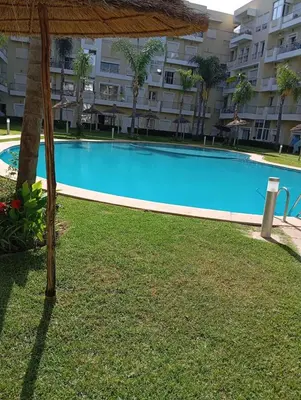 a large swimming pool in front of a building at Appartement vue panoramique in Bouznika