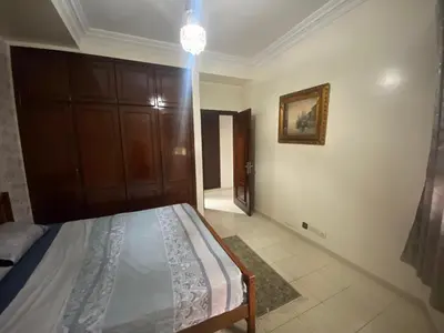 a bedroom with a bed and a chandelier at casablanca,bourgogne,corniche in Casablanca