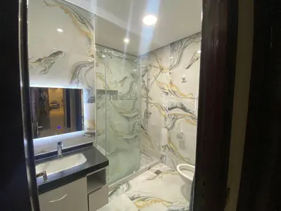a bathroom with a shower and a sink and a mirror at casablanca,bourgogne,corniche in Casablanca