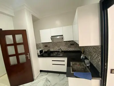a small kitchen with white cabinets and a sink at casablanca,bourgogne,corniche in Casablanca