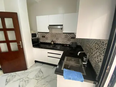a kitchen with white cabinets and marble counter tops at casablanca,bourgogne,corniche in Casablanca