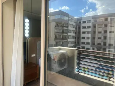 a balcony with a view of a building at Furnished studio with pool in Nouaseur