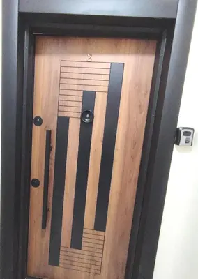 a wooden door with a keyboard on it at Aeroport Tissir Appartement in Nouaceur