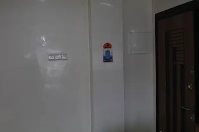 a white wall with magnets on it next to a door at Aeroport Tissir Appartement in Nouaceur