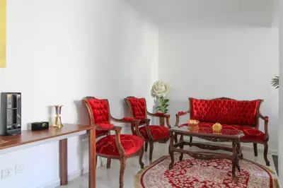 a living room with red chairs and a table at Studio Panoramique, Mosquée Hassan II, Cœur de la Médina in Casablanca