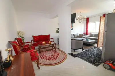 a living room with red chairs and a table at Studio Panoramique, Mosquée Hassan II, Cœur de la Médina in Casablanca