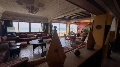 a living room with couches and a table and chairs at Zaouia in Rabat