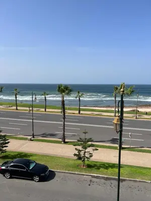a black car parked on the side of a road near the ocean at Zaouia in Rabat