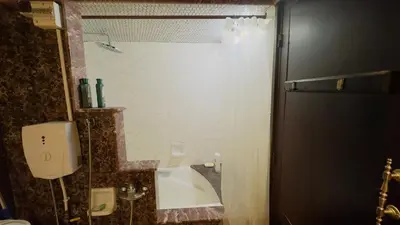 a bathroom with a shower with a tub and a sink at Zaouia in Rabat